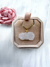 Dreamy Jade white carved floral jade pendant on a gold box chain, presented in a beige velvet jewellery box.