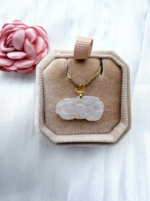 Dreamy Jade white carved floral jade pendant on a gold box chain, presented in a beige velvet jewellery box.